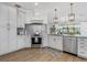 Bright kitchen features white cabinets, stainless steel appliances, and an open concept layout at 10880 Cory Lake Dr, Tampa, FL 33647