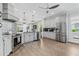 Modern kitchen features stainless steel appliances, gray cabinetry, and an open layout at 10880 Cory Lake Dr, Tampa, FL 33647