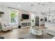 Bright living room features a stone accent wall, large windows, and modern decor at 10880 Cory Lake Dr, Tampa, FL 33647