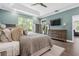 Comfortable main bedroom featuring a ceiling fan, a large window, and an entertainment center at 10880 Cory Lake Dr, Tampa, FL 33647