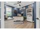 Home office with a built in desk and bookshelf, as well as an area rug and ample natural light at 10880 Cory Lake Dr, Tampa, FL 33647
