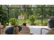 Screened patio with a view of the backyard, featuring a storage shed, lush greenery, and ample sunlight at 10880 Cory Lake Dr, Tampa, FL 33647