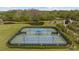 Aerial view of well-maintained tennis courts with spectator seating and manicured landscaping at 10880 Cory Lake Dr, Tampa, FL 33647