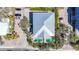 Stunning aerial view of luxury home with dual pools, lush landscaping, and convenient parking at 1204 Derby Ln, Sarasota, FL 34242
