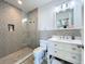 Beautiful bathroom featuring a walk-in shower with mosaic tile and a white vanity with marble countertop at 1204 Derby Ln, Sarasota, FL 34242