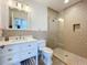 Stylish bathroom with modern vanity, a toilet, and a glass-enclosed shower featuring tile walls and a showerhead at 1204 Derby Ln, Sarasota, FL 34242
