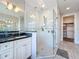 Bright bathroom featuring a glass shower, stylish vanity, and access to the walk-in closet at 1204 Derby Ln, Sarasota, FL 34242