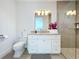 A clean and bright bathroom features a granite counter top, white vanity, and glass-enclosed shower at 1204 Derby Ln, Sarasota, FL 34242