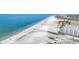 Wide sandy beach with clear blue ocean provides a perfect setting for seaside vacations and coastal living at 1204 Derby Ln, Sarasota, FL 34242