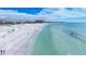 Scenic aerial view of sandy beach with turquoise water, perfect for swimming, sunbathing, and beachfront strolls at 1204 Derby Ln, Sarasota, FL 34242