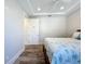 Bedroom featuring stylish decor, wood-style floors, and a door, creating a peaceful and private retreat at 1204 Derby Ln, Sarasota, FL 34242