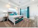 Stylish bedroom with a decorative wood bed, contemporary furnishings, and natural light at 1204 Derby Ln, Sarasota, FL 34242