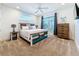 Cozy bedroom with a unique wood bed, bedside tables, and natural light from the window at 1204 Derby Ln, Sarasota, FL 34242
