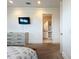 Spacious bedroom with a TV, dresser, and bathroom access at 1204 Derby Ln, Sarasota, FL 34242