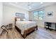 Bright bedroom with a large window, wood-style flooring, a cozy bed, and functional furniture for relaxing at 1204 Derby Ln, Sarasota, FL 34242