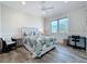 This lovely bedroom features hardwood floors, wainscotting, and great natural light at 1204 Derby Ln, Sarasota, FL 34242