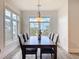 Bright dining room features a modern chandelier, large windows, and seating for eight at 1204 Derby Ln, Sarasota, FL 34242
