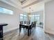 Light and airy dining room boasts wood-look tile floors, bright windows, and seating for eight at 1204 Derby Ln, Sarasota, FL 34242