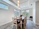 Bright dining area featuring a wood table, chair seating for six, and large windows at 1204 Derby Ln, Sarasota, FL 34242