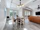 Bright dining area with wood table, chair seating for six, and large windows providing ample natural light at 1204 Derby Ln, Sarasota, FL 34242
