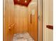 This residential elevator features wood paneling, safety rails, and tile floor at 1204 Derby Ln, Sarasota, FL 34242