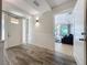 The well-lit entryway boasts elegant wainscotting, stylish decor, and access to main living areas at 1204 Derby Ln, Sarasota, FL 34242