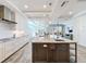 Bright kitchen featuring stainless steel appliances, a large island with marble countertops, and white cabinetry at 1204 Derby Ln, Sarasota, FL 34242