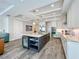 Open kitchen with stainless steel appliances, a wine fridge, marble countertops, and an island with seating at 1204 Derby Ln, Sarasota, FL 34242
