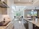 Well-lit kitchen with stainless steel appliances, marble countertops, and an open view to the dining area at 1204 Derby Ln, Sarasota, FL 34242