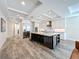 Spacious kitchen with stainless steel appliances, a large center island with seating, and an open floor plan at 1204 Derby Ln, Sarasota, FL 34242
