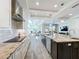 Modern kitchen with sleek appliances, a large island with seating, and an open layout to the dining and living areas at 1204 Derby Ln, Sarasota, FL 34242