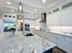 Gourmet kitchen featuring a large marble island, custom cabinets, and stainless steel appliances at 1204 Derby Ln, Sarasota, FL 34242