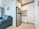 Convenient kitchenette with white cabinets, a stainless steel refrigerator, and a sink, perfect for easy meal prep at 1204 Derby Ln, Sarasota, FL 34242