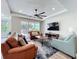 Inviting living room with comfortable leather seating, ceiling fan, and sliding glass doors to the outdoor patio at 1204 Derby Ln, Sarasota, FL 34242