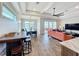 Open-concept living space combining kitchen, dining, and living area with abundant natural light and stylish furnishings at 1204 Derby Ln, Sarasota, FL 34242