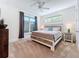 This spacious main bedroom features neutral carpet, natural light, and a decorative ceiling fan at 1204 Derby Ln, Sarasota, FL 34242