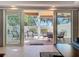 View of the outdoor patio area with a pool and various seating options, accessible through sliding glass doors at 1204 Derby Ln, Sarasota, FL 34242