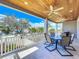 This relaxing patio features a wood plank ceiling, ceiling fan, and outdoor seating at 1204 Derby Ln, Sarasota, FL 34242