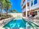 Inviting backyard pool with lounge chairs and lush landscaping creates a private oasis for relaxation at 1204 Derby Ln, Sarasota, FL 34242