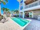 Backyard with a sparkling pool, lounge chairs, dining area, outdoor kitchen and access to the house at 1204 Derby Ln, Sarasota, FL 34242