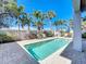 This private pool is surrounded by tropical landscaping and a brick patio, perfect for entertaining guests at 1204 Derby Ln, Sarasota, FL 34242