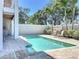 Backyard with a private in-ground pool, a patio area with lounge chairs, and lush tropical landscaping at 1204 Derby Ln, Sarasota, FL 34242