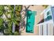 Aerial view of private pool surrounded by lush tropical landscaping offers a luxurious outdoor experience at 1204 Derby Ln, Sarasota, FL 34242