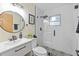 Modern bathroom with a glass enclosed shower and black and white patterned tile at 1206 E Osborne Ave, Tampa, FL 33603