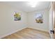 Bright bedroom with wood look floors and natural light streaming through the windows at 1206 E Osborne Ave, Tampa, FL 33603