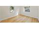 A bright, neutral-toned bedroom featuring wood look floors and ample light from the windows at 1206 E Osborne Ave, Tampa, FL 33603