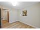 Cozy bedroom with wood look floors and an adjacent laundry room at 1206 E Osborne Ave, Tampa, FL 33603