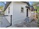 Side view of home showing newly painted exterior, windows, and fenced yard at 1206 E Osborne Ave, Tampa, FL 33603