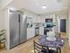 Modern kitchen with white cabinets, stainless steel appliances, and eat-in dining area at 1206 E Osborne Ave, Tampa, FL 33603