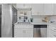 Kitchen with stainless steel refrigerator, undermount sink and modern cabinetry at 1206 E Osborne Ave, Tampa, FL 33603